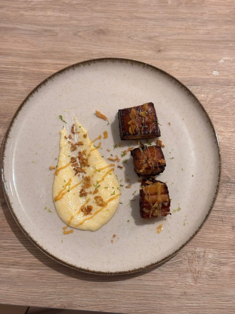 Plat gastronomique avec morceaux de viande rôtie et purée sauce sur assiette blanche